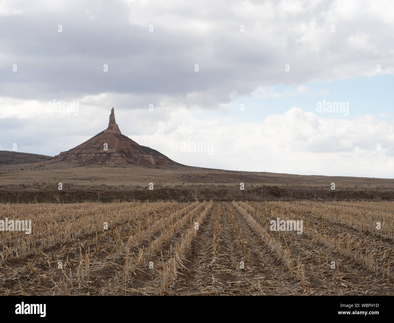 Chimney Rock National Historic Site in Nebraska with stubble field in the foreground. Stock Photo