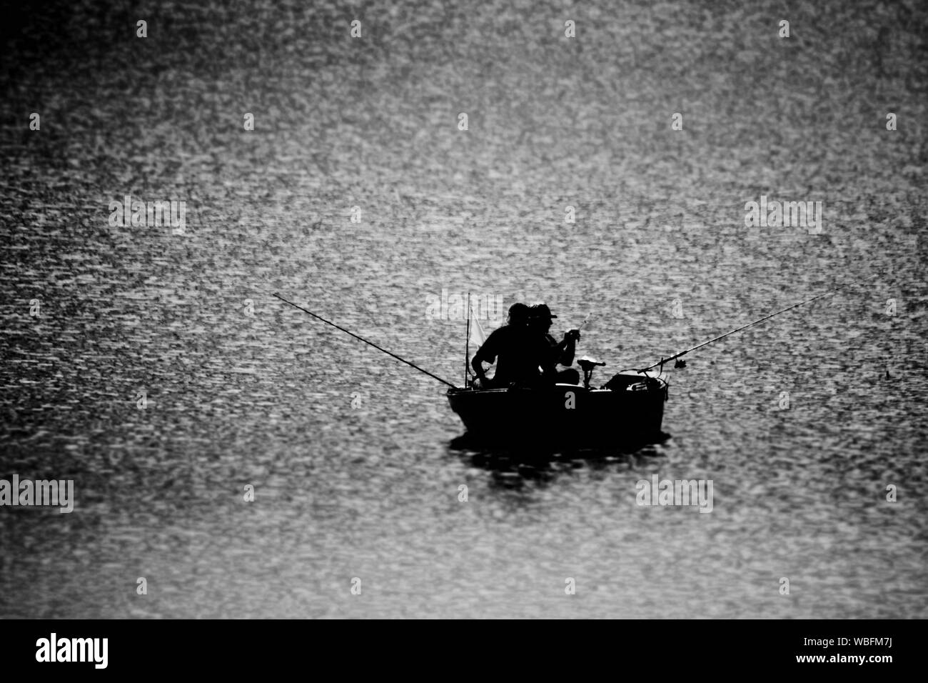 Two men fishing boat Black and White Stock Photos & Images - Alamy