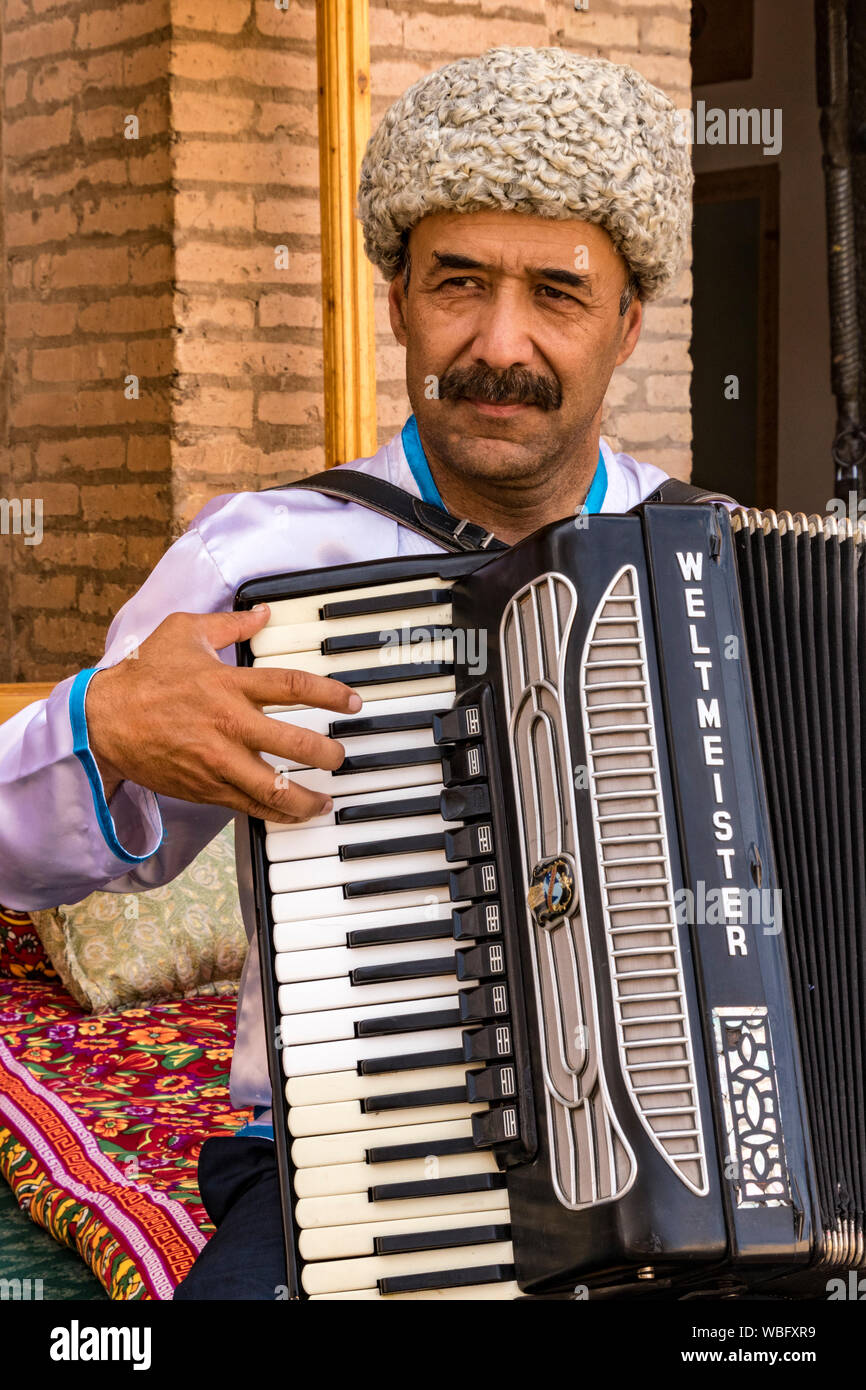 Khiva, Uzbekistan - May 23, 2017 - Man plays traditional Uzbekistan music on accordion Stock Photo