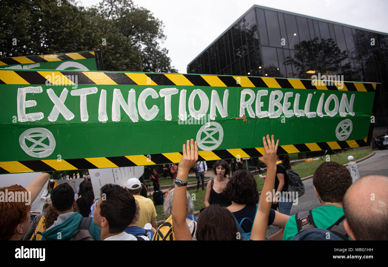 'Extinction Rebellion' reads the sign. In response to the burning of the Amazon rainforest, environmental activists gathered in front of the Brazilian Embassy in Washington, DC on Monday August 26, 2019. The protest was designed to put pressure on Brazilian president Jair Bolsonaro to stop the fires and protect the Amazon and its indigenous peoples. Extinction Rebellion, according to Wikipedia, is a socio-political movement with the stated aim of using civil disobedience and nonviolent resistance to protest against climate breakdown, biodiversity loss, and the risk of social and ecological co Stock Photo