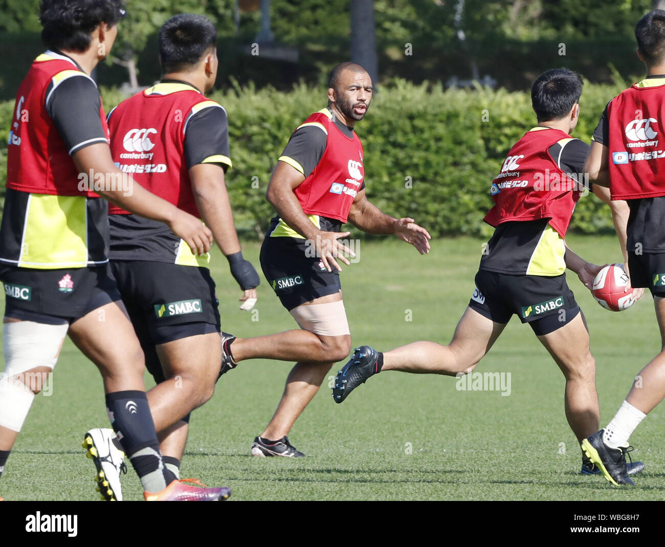 Michael Leitch (facing) and other Japan national rugby team members ...