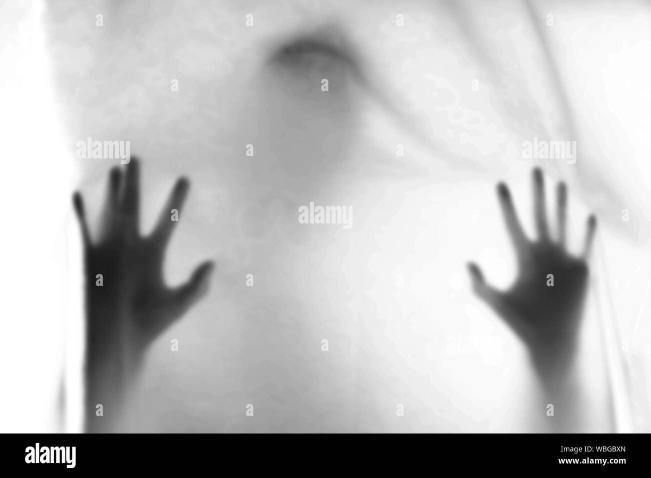 Shadow blur of horror man.Hands on the white cloth. Halloween background.Black and white picture.Blur picture Stock Photo