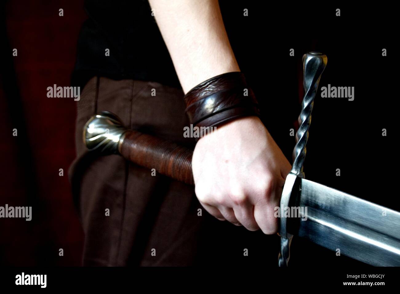 Cropped Hand Holding Sword Stock Photo - Alamy