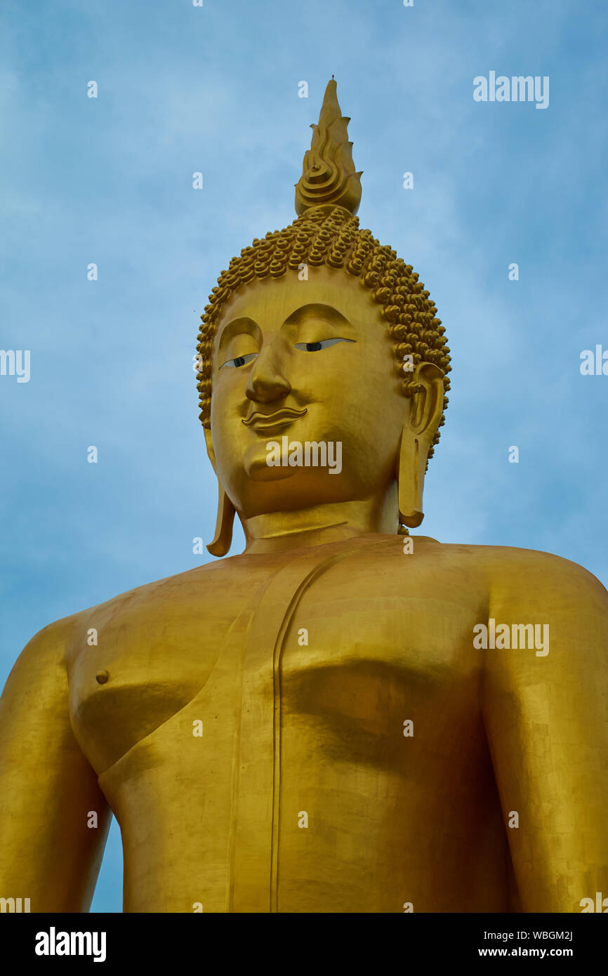 A giant, gold sitting Buddha at Wat Muang in Ang Thong, Thailand. Stock Photo