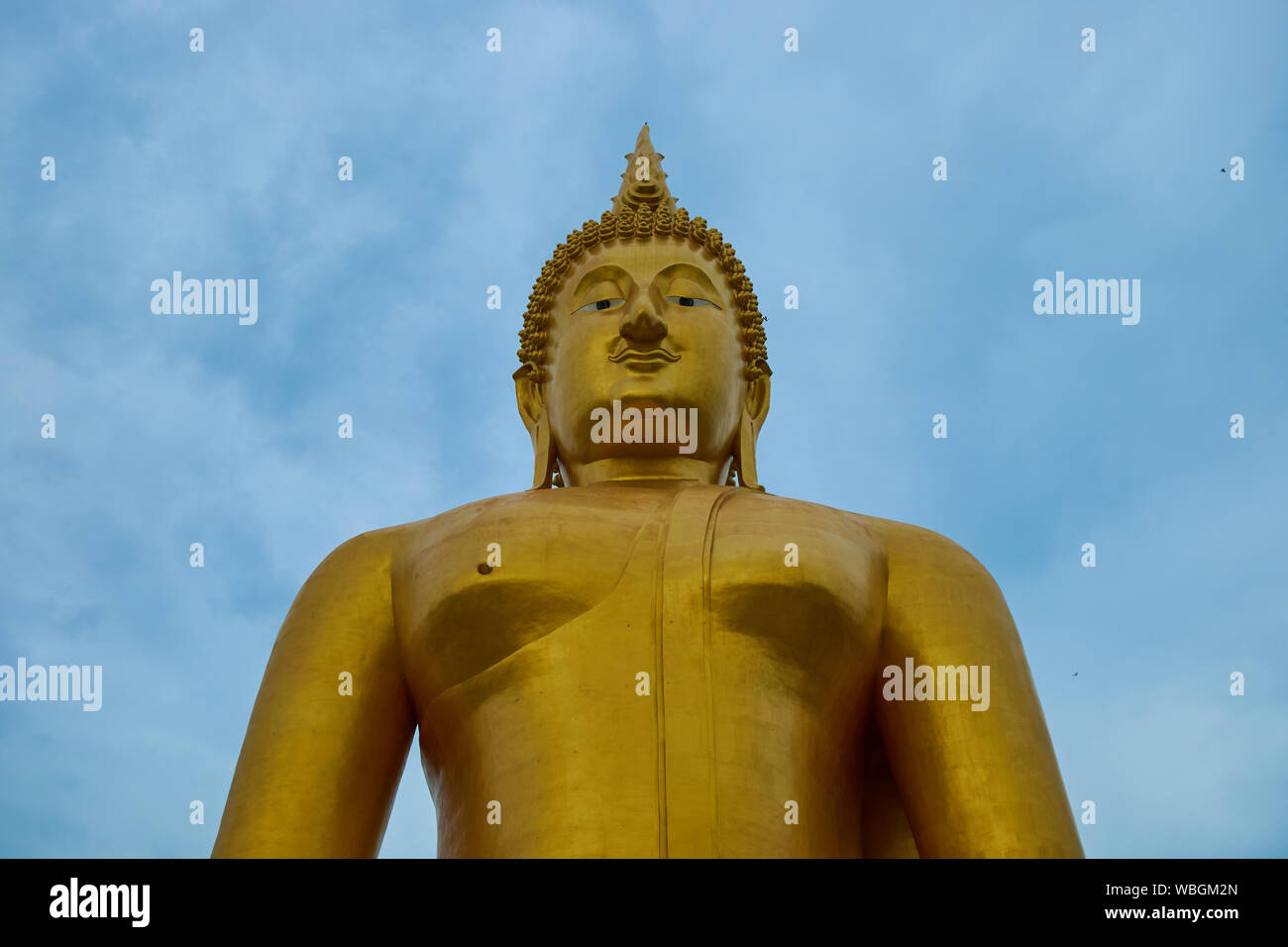 A giant, gold sitting Buddha at Wat Muang in Ang Thong, Thailand. Stock Photo