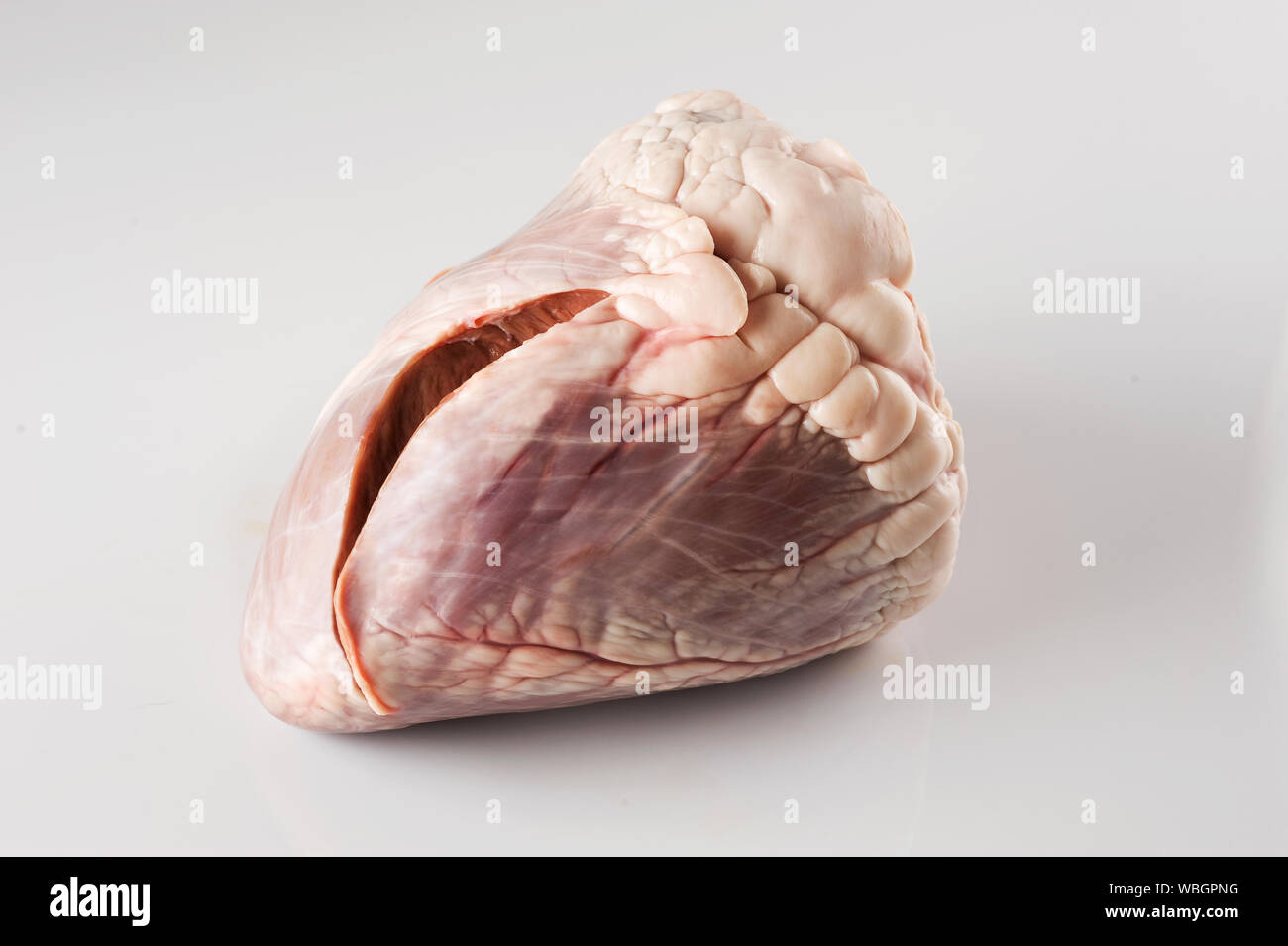 Organic meat. Beef heart is an extremely flavorful meat for cooking a delicious dinner.The heart is natural raw pet food diet. . Stock Photo