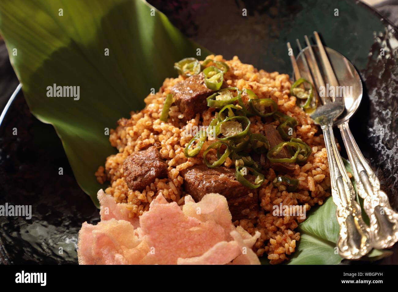 Nasi Goreng Rendang. Indonesian fried rice with Beef Rendang and its spice mix Stock Photo