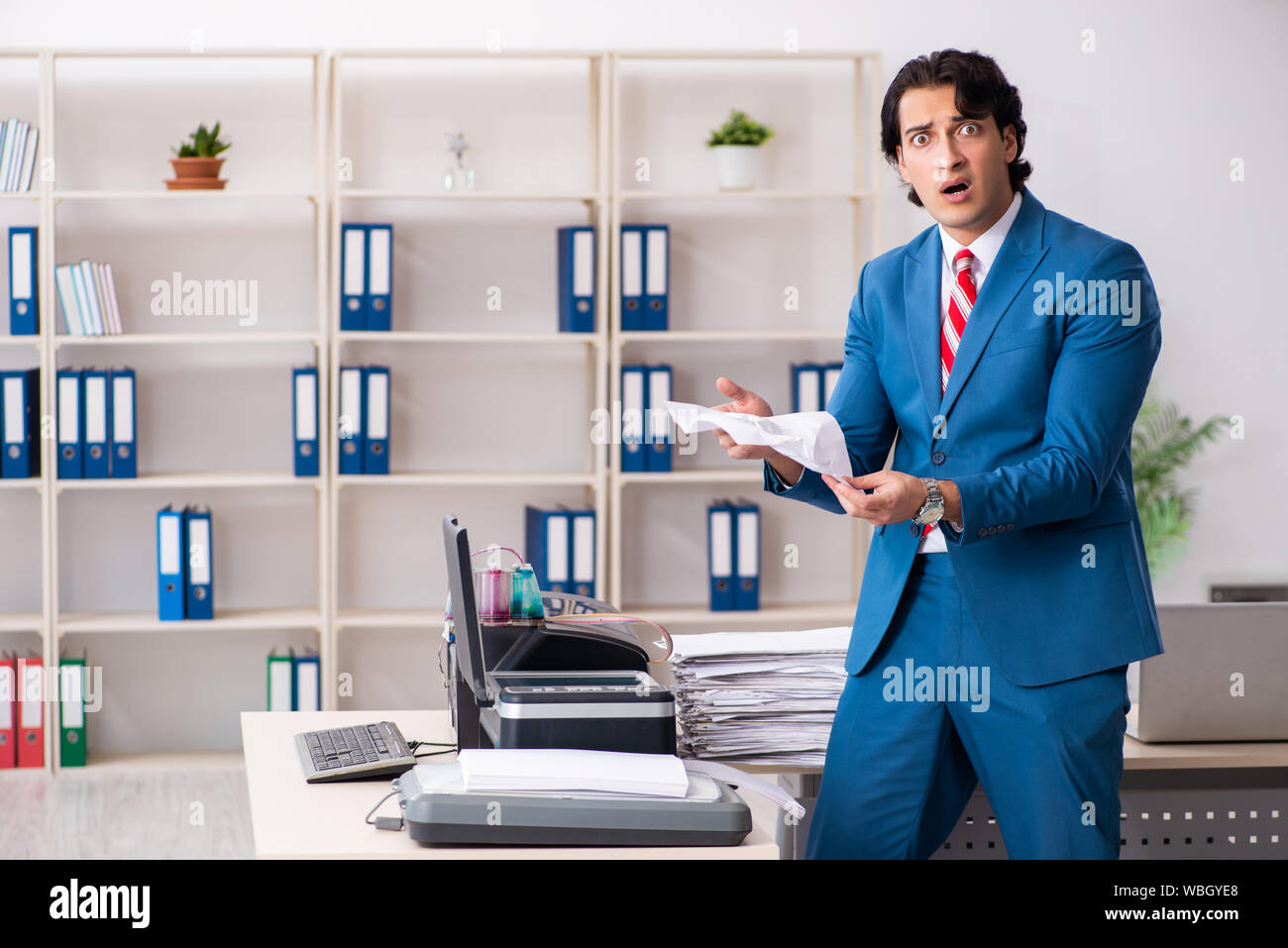 Working Copy Cop The young employee making copies at copying machine Stock Photo - Alamy