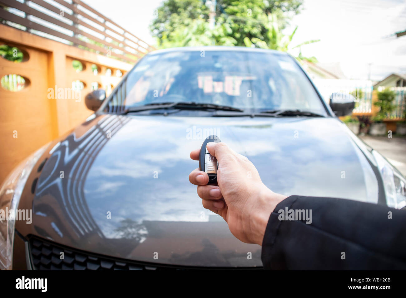Businessman Opening His Car Door With Pushing Button On Control
