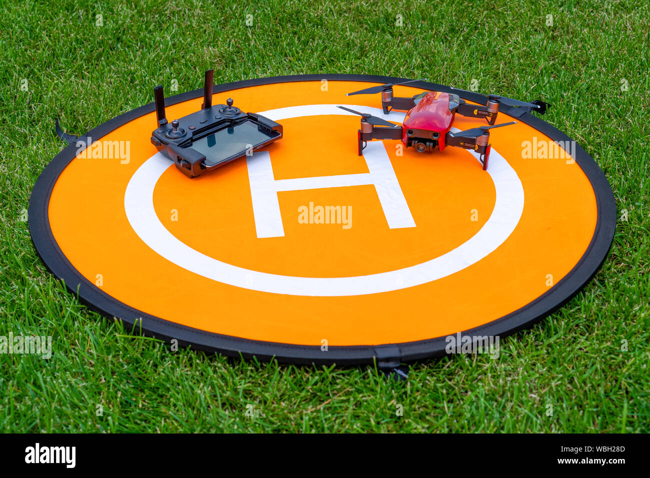 Russia, Tatarstan, June 15, 2019. Drone on the heliport. drone phone and  control panel on an orange helipad on the grass Stock Photo - Alamy