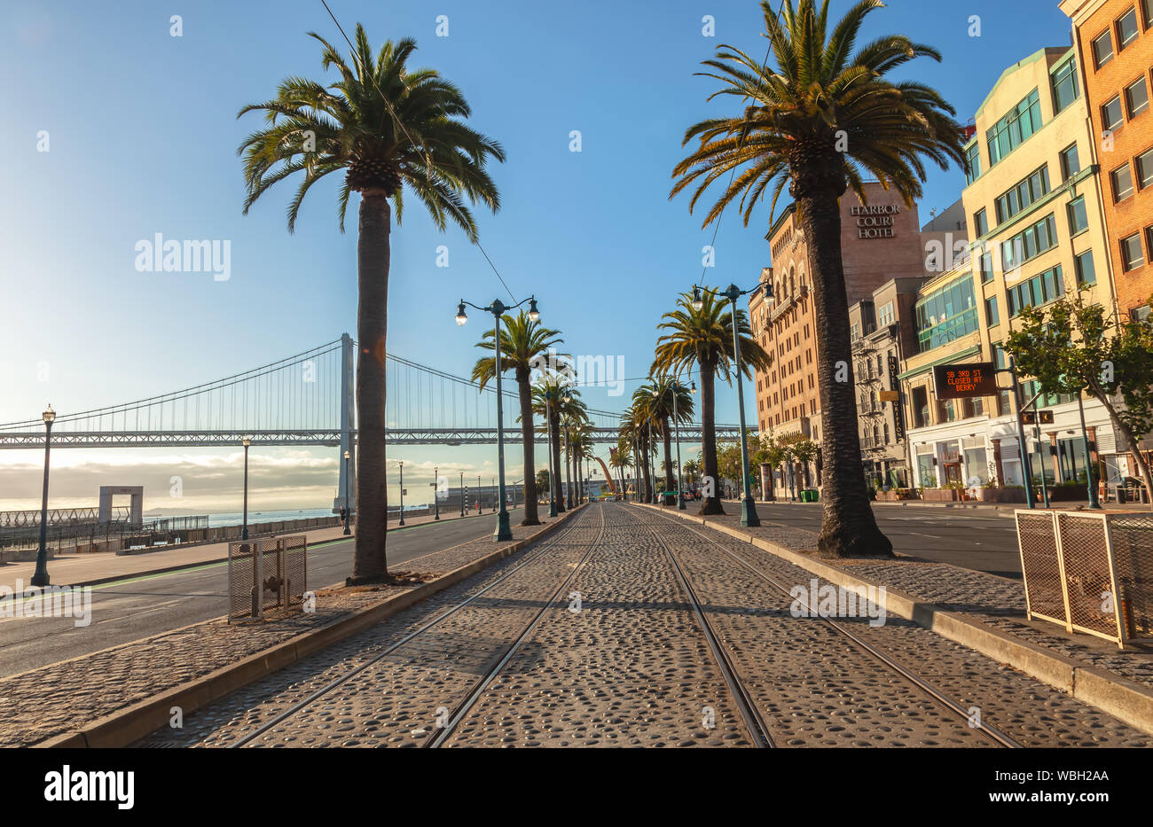 Rail tracks for trolley buses and the landscape of Embarcadero Street in San Francisco, California, USA Stock Photo