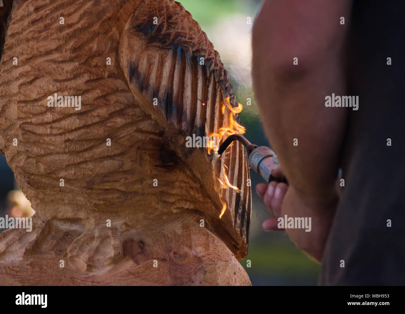 Man Using Blowtorch Wooden man sculpture hi-res stock photography and images - Alamy