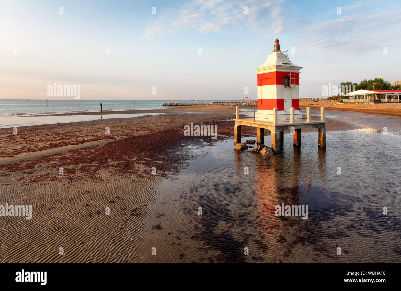 Italy beach - Lignano Sabbiadoro Lighthouse with beach at sunrise Stock Photo