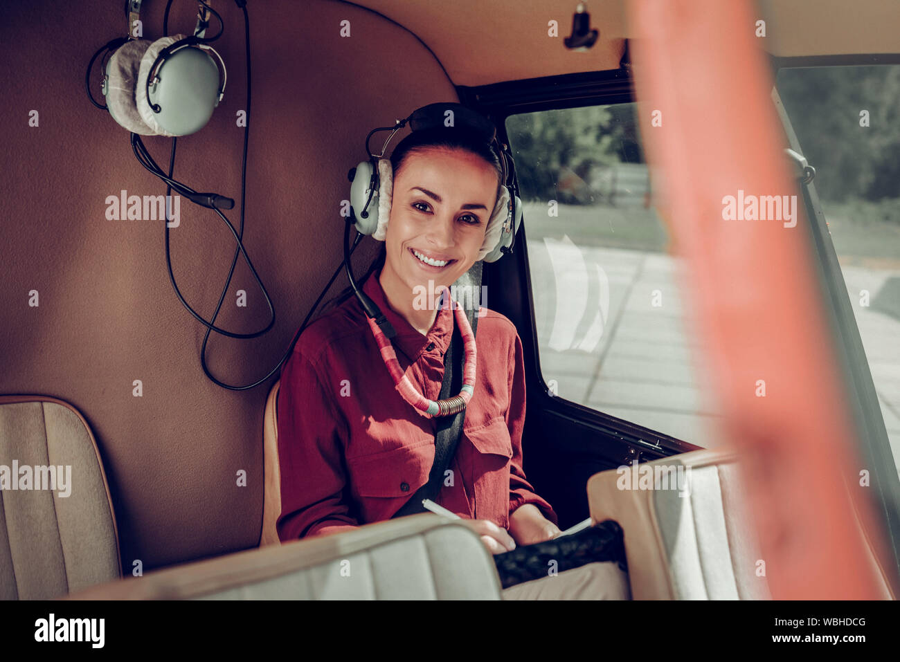 Beautiful Woman Enjoying Her Short Flight In The Helicopter Stock Photo