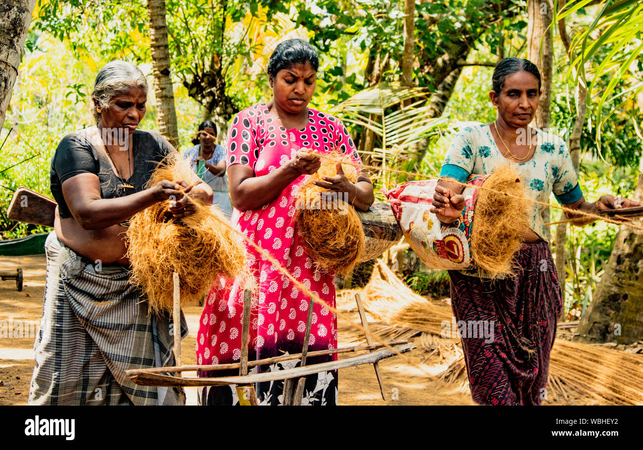 MONROE ISLAND, INDIA, MAR 15, 2018: Women spin coconut hair by hand, turning it into a strong rope Stock Photo