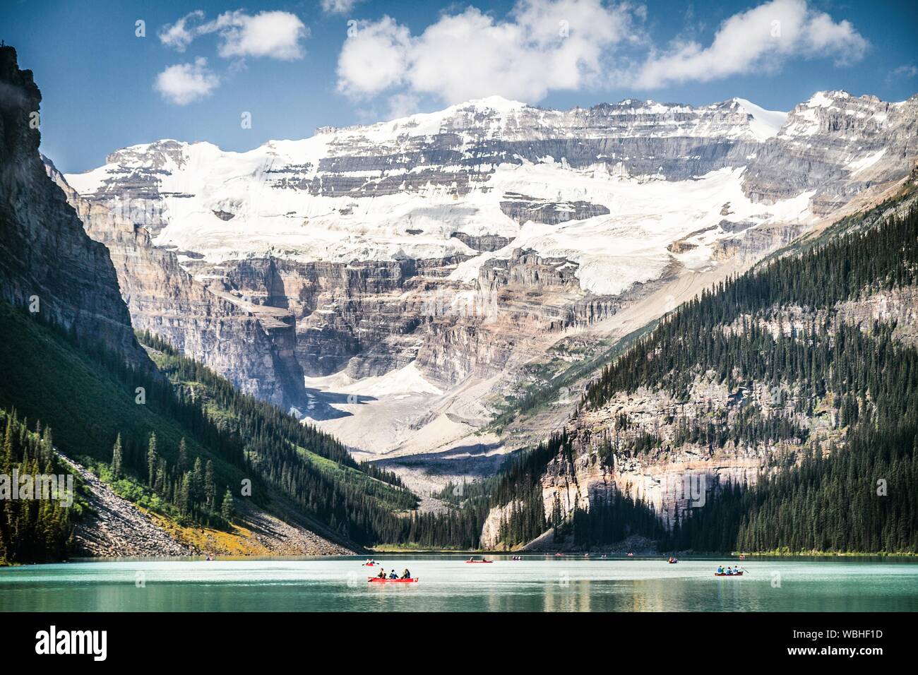 Lake Louise Against Snow Covered Mountains Stock Photo