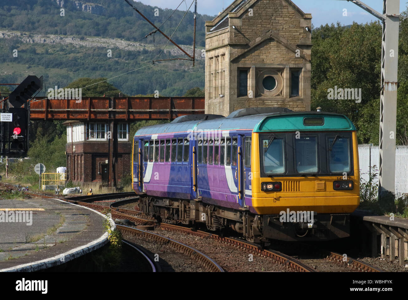 BREL Pacer class 142 diesel multiple unit passenger train in old Northern livery arriving at Carnforth railway station on Monday 26th August 2019. Stock Photo