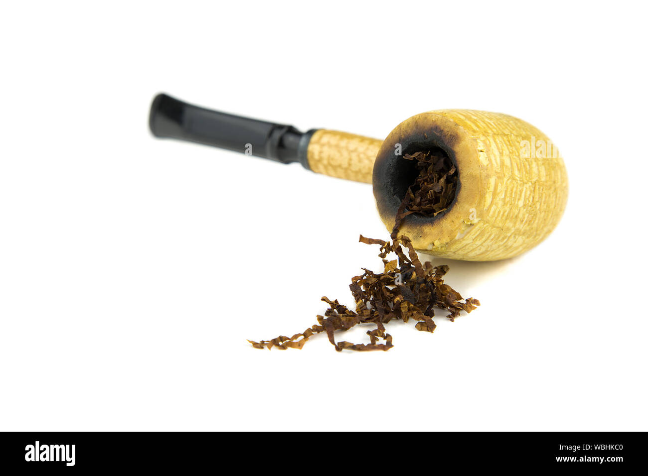 Close-up Of Smoking Pipe With Tobacco Against White Background Stock Photo