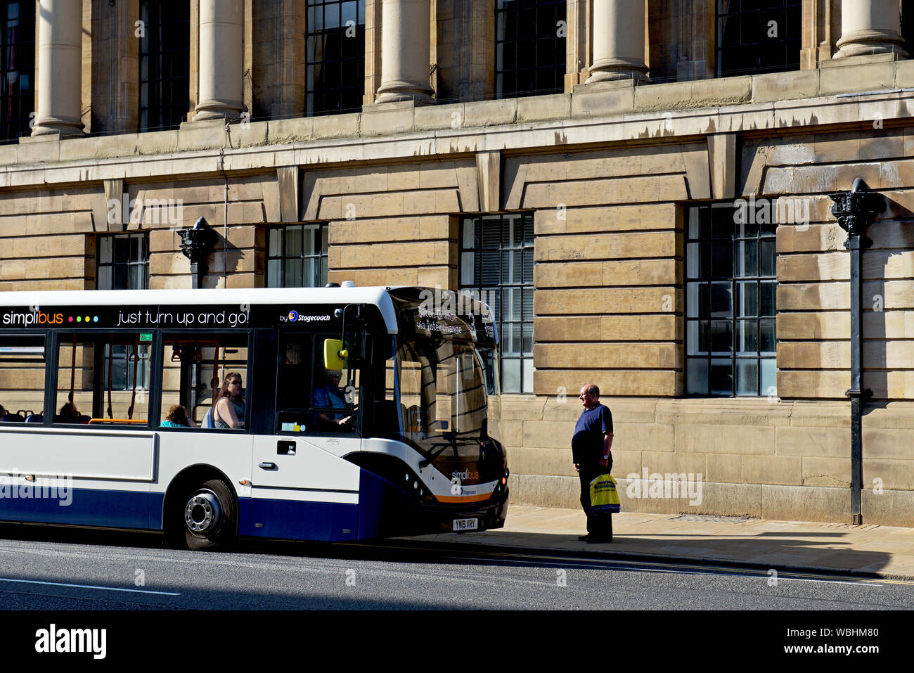 Bus stopping to pick up male passenger on Alfred Gelder Street, Hull, East Yorkshire, England UK Stock Photo