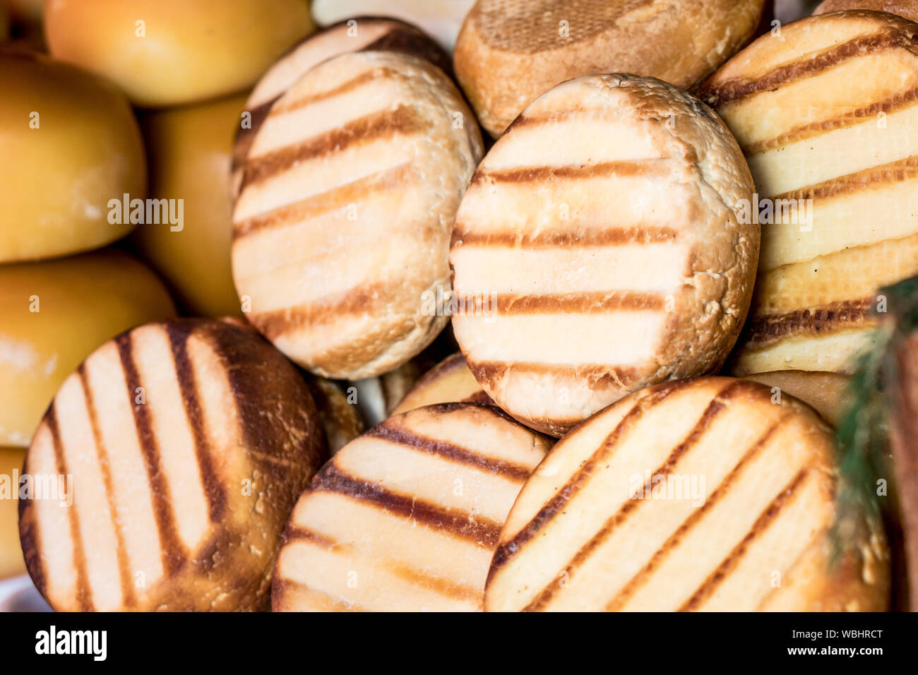 Traditional romanian  smoked sheep cheeses cas and cascaval on a shelf Stock Photo