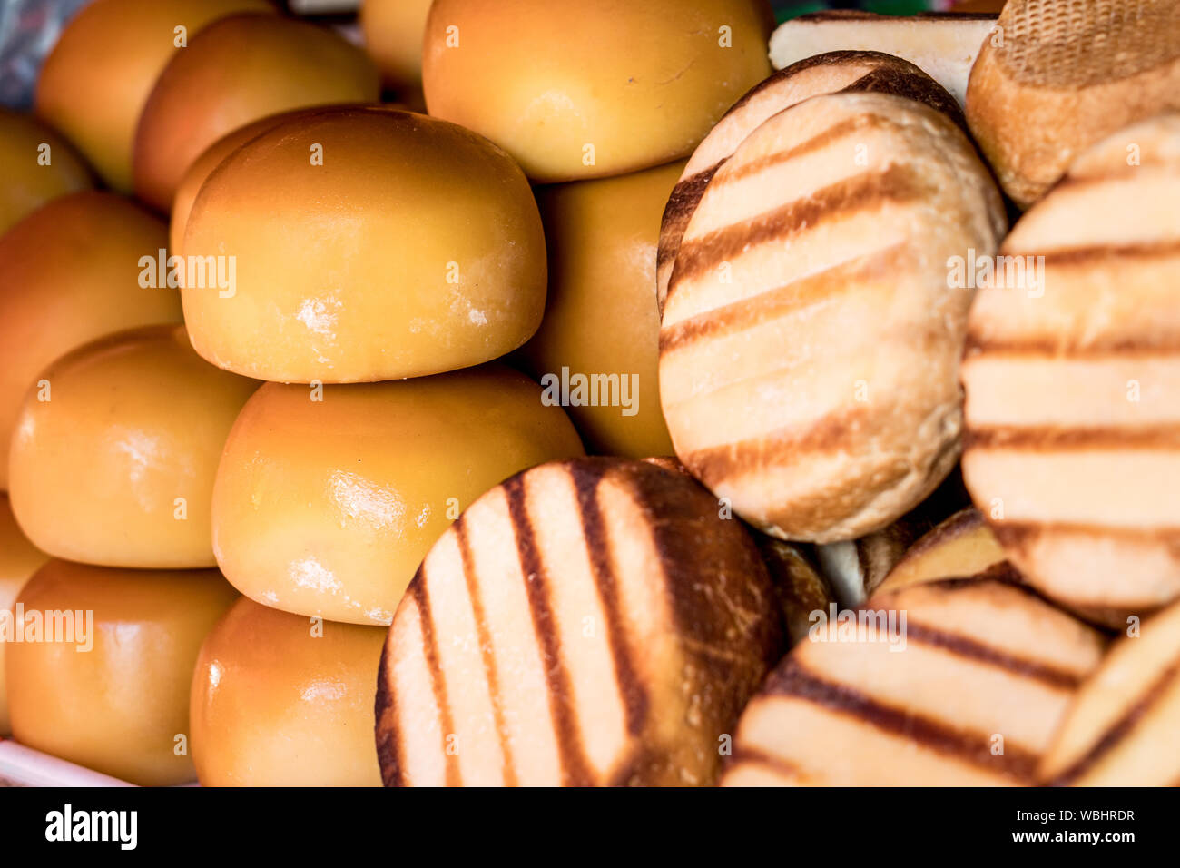 Traditional romanian  smoked sheep cheeses cas and cascaval on a shelf Stock Photo