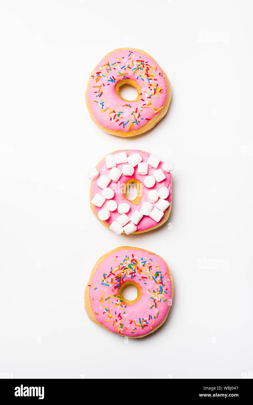 Fresh sweet pink bonuts on white studio background Stock Photo