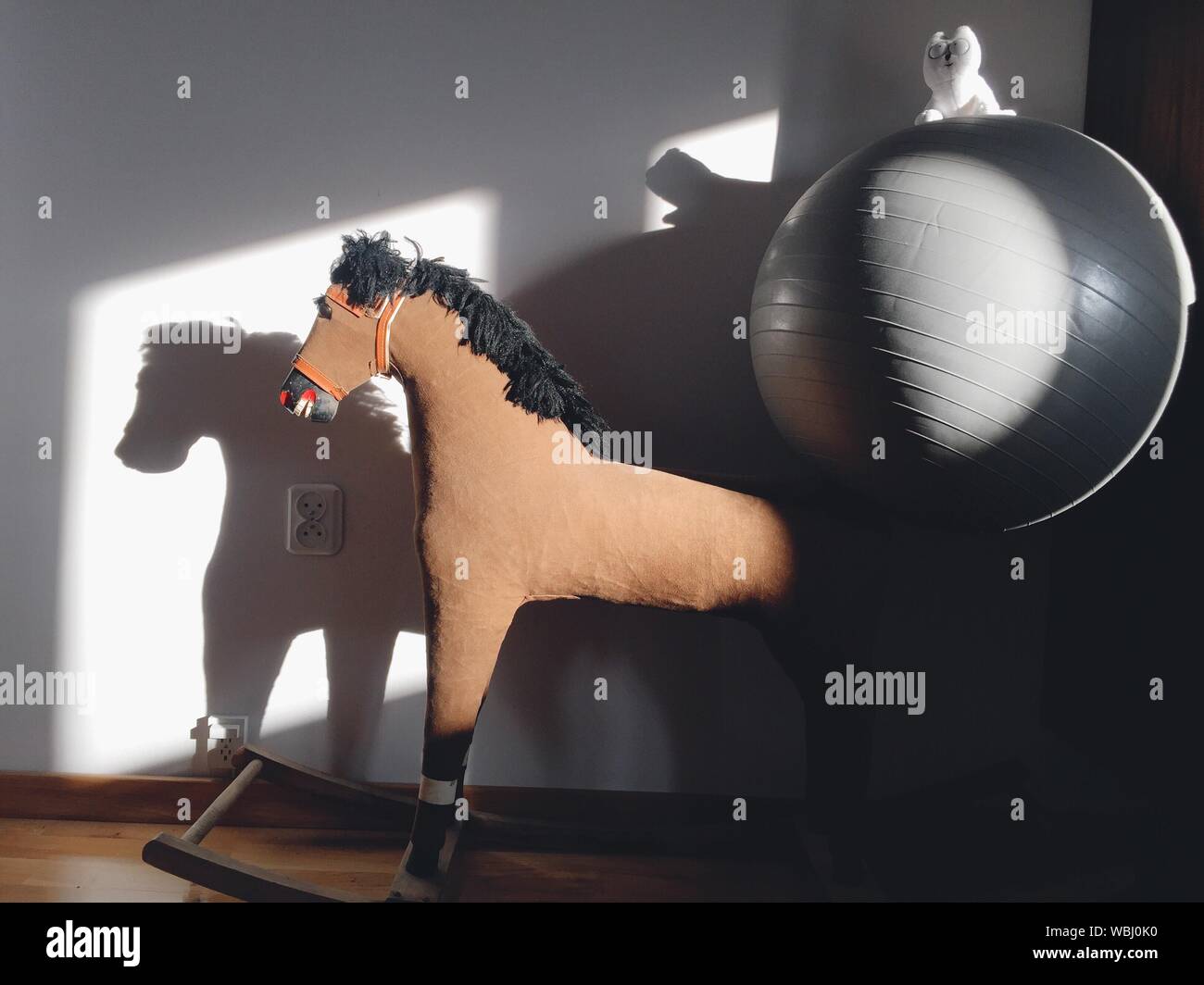 Rocking Horse With Ball By Wall Stock Photo Alamy