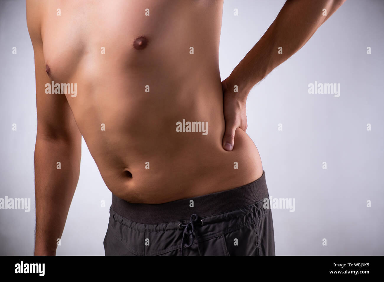 The man suffering from backbain on gray Stock Photo