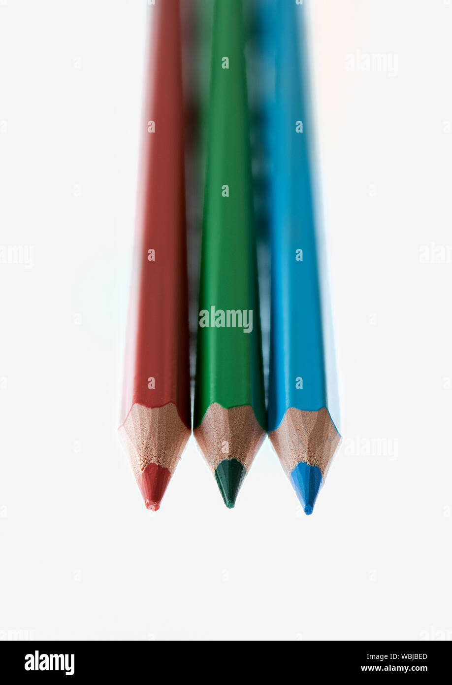 Red, green and blue coloured pencils against a white background Stock Photo