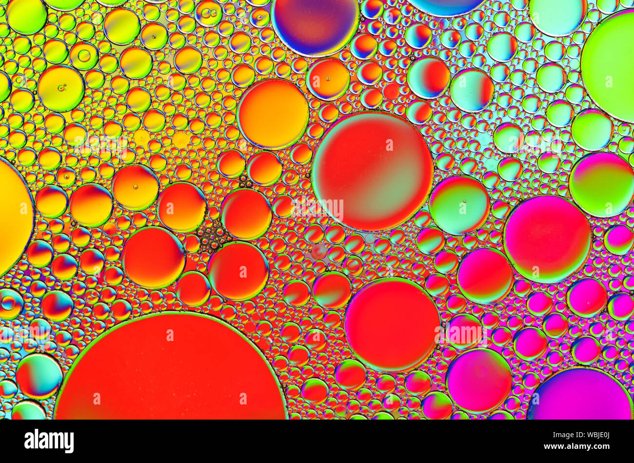 Multi-coloured bubble patterns formed by oil floating on water Stock ...
