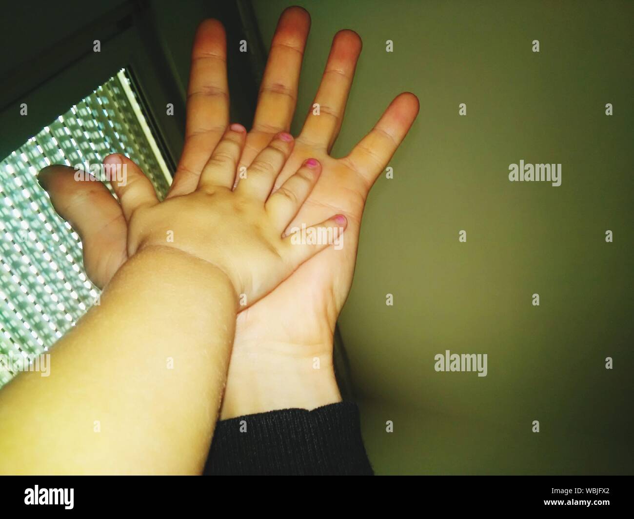 Mother And Toddler's Hands Stock Photo
