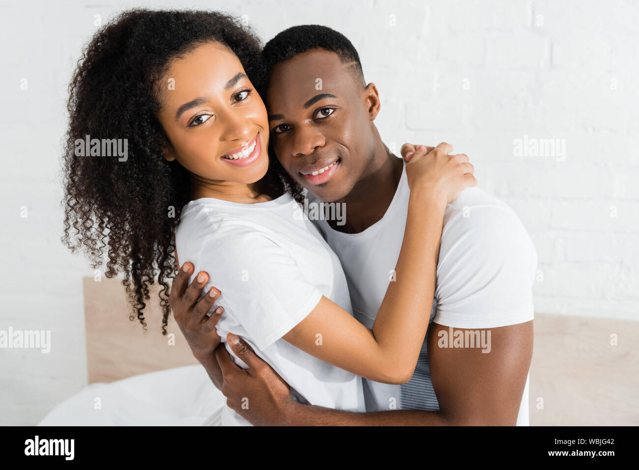 african american couple hugging each other and looking at camera Stock ...