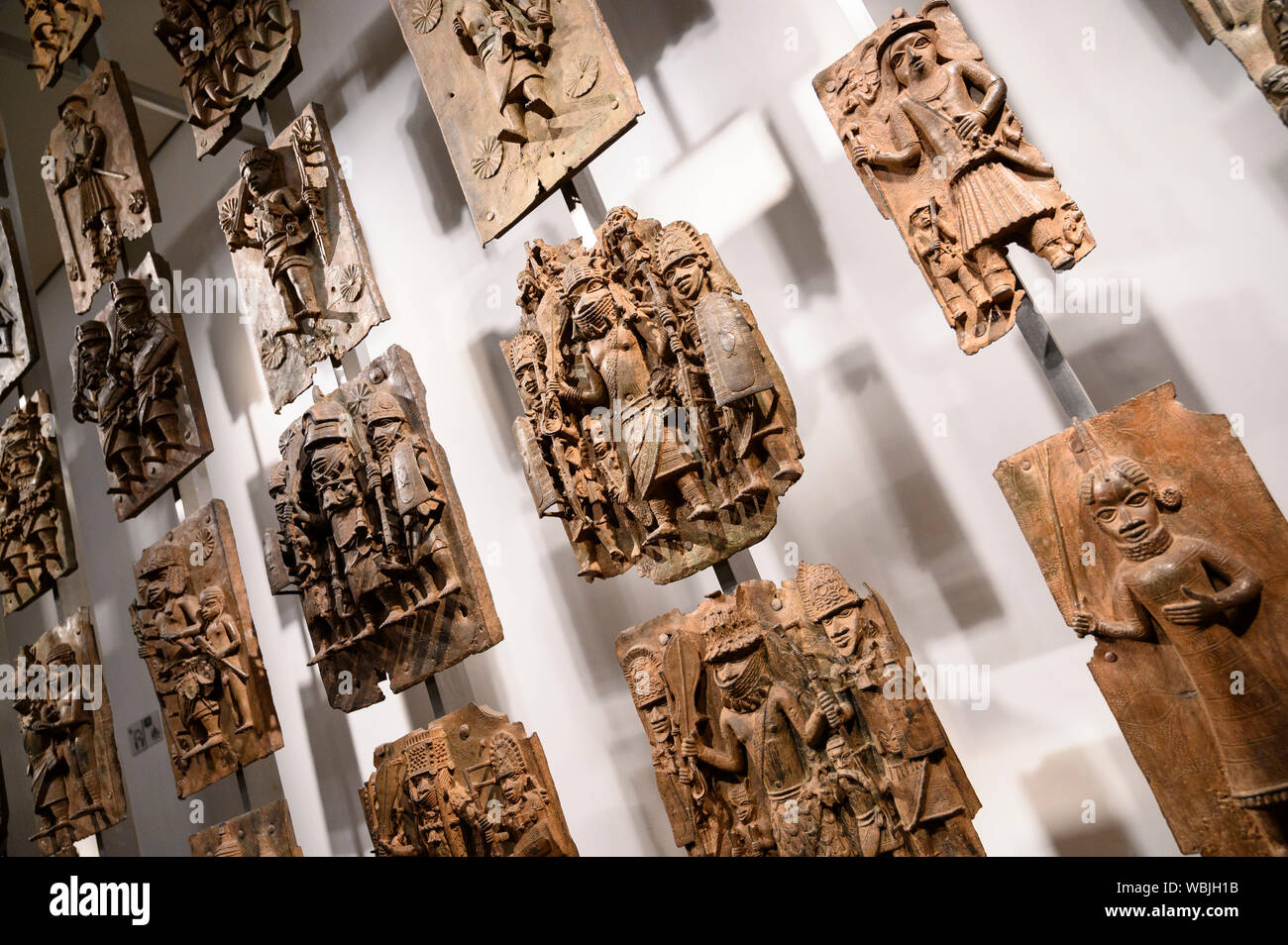 London. England. Benin Bronzes on display at the British Museum, brass plaques from the royal court palace of the Kingdom of Benin, 16-17th century. Stock Photo