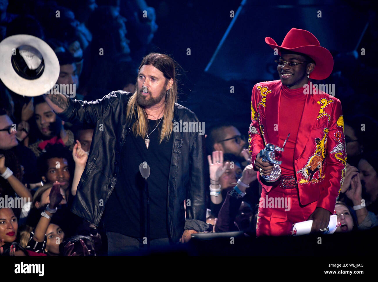 Lil Nas X and Billy Ray Cyrus collecting the award for Song of the Year on  stage at the MTV Video Music Awards 2019 held at the Prudential Center in  Newark, New