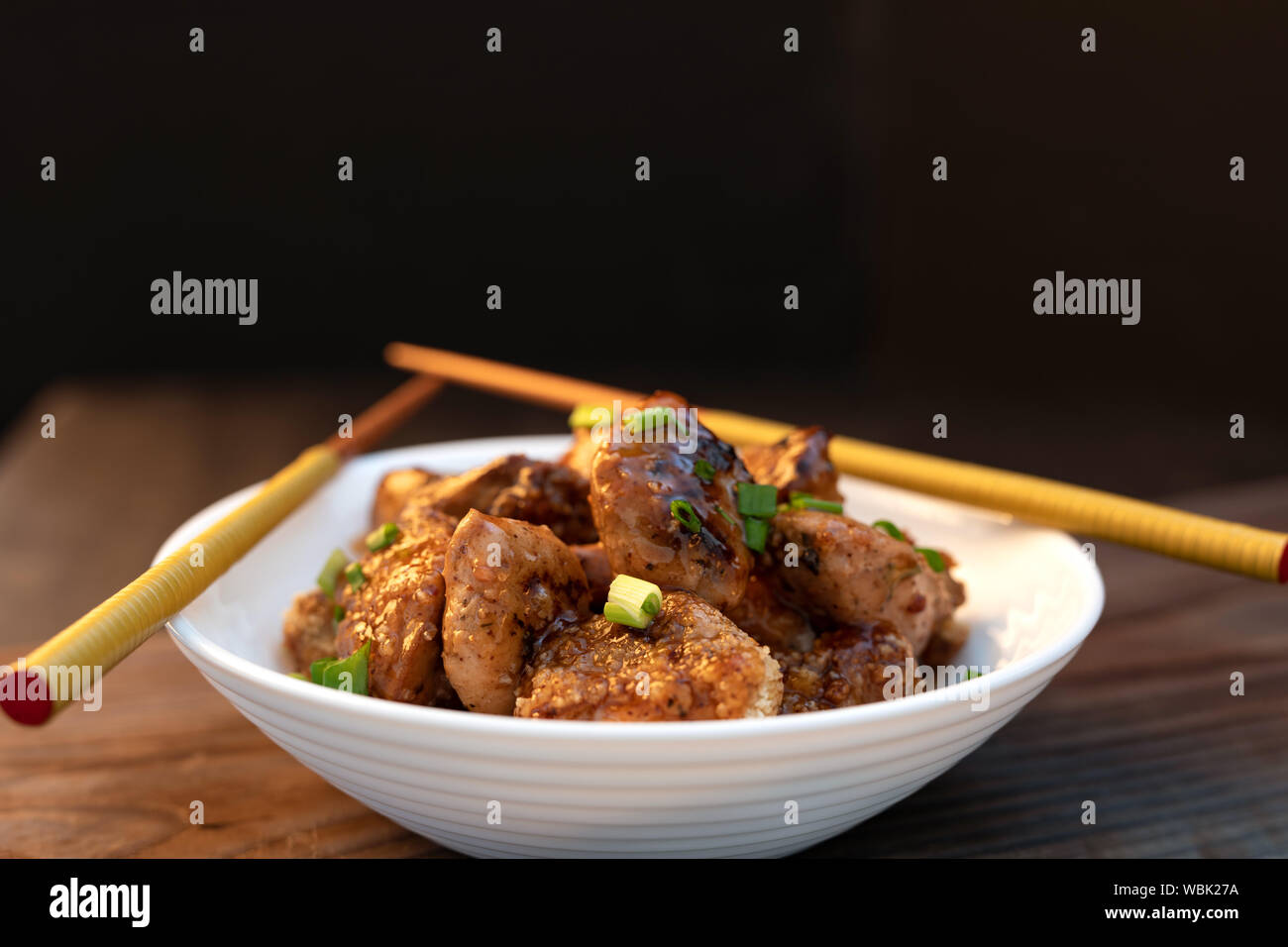 Asian Orange Chicken with Green Onions for Dinner. Chinese chicken sweet and sour sauce. Teriyaki Stock Photo