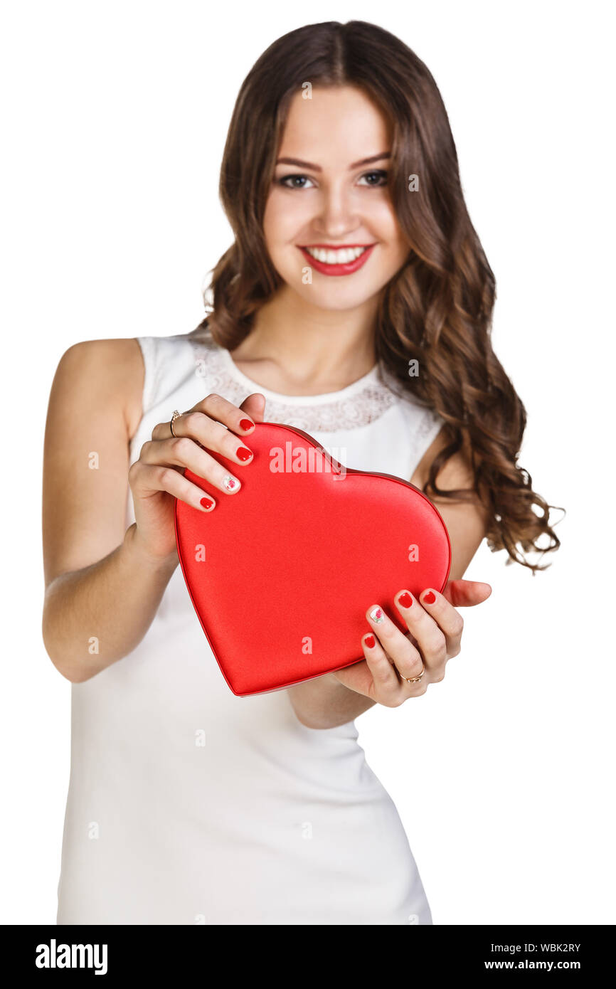 Young woman in white dress holds heart shaped box. Isolated on white background Stock Photo