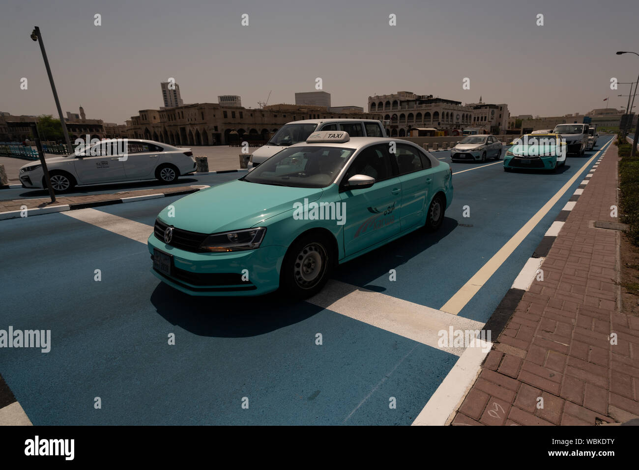 The Public Works Authority in Qatar (Ashghal) has implemented a pilot 'cool pavement' project in the capital, Doha, which involves the use of a cryogenic material to reduce the temperature of the asphalt on roads. Unlike conventional asphalt, which contributes to increased temperatures by absorbing up to 95 percent of sunlight, the 'cool pavement' reflects UV rays and absorbs solar radiation to a lesser extent, thereby contributing to overall temperature reduction. Ashghal says the project will last for 18 months and based on the outcome of the pilot, it will determine its wider applications. Stock Photo