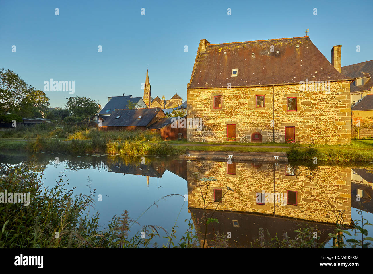 Image of Tinteniac, France with the canal in the foreground Stock Photo