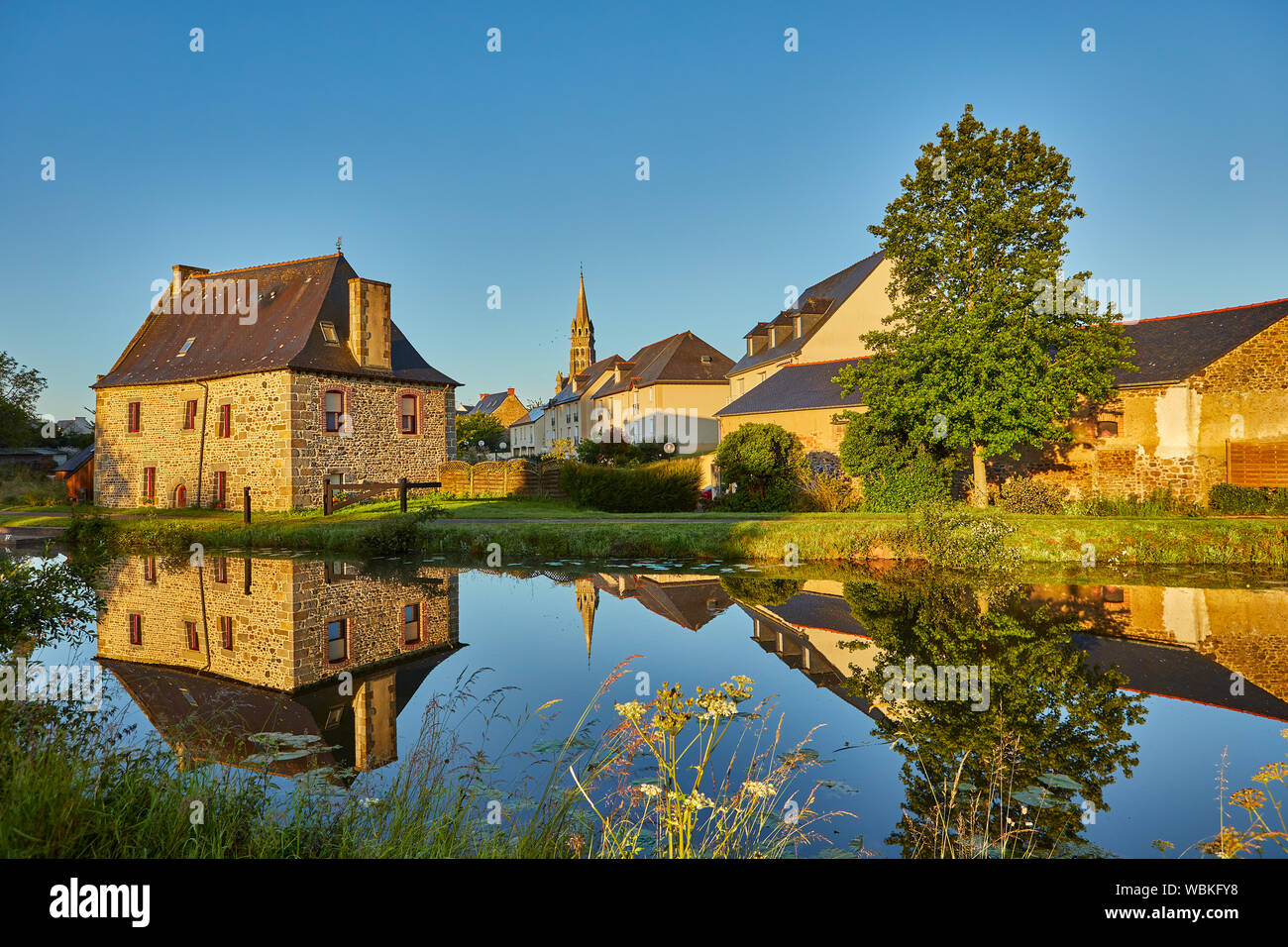 Image of Tinteniac, France with the canal in the foreground Stock Photo