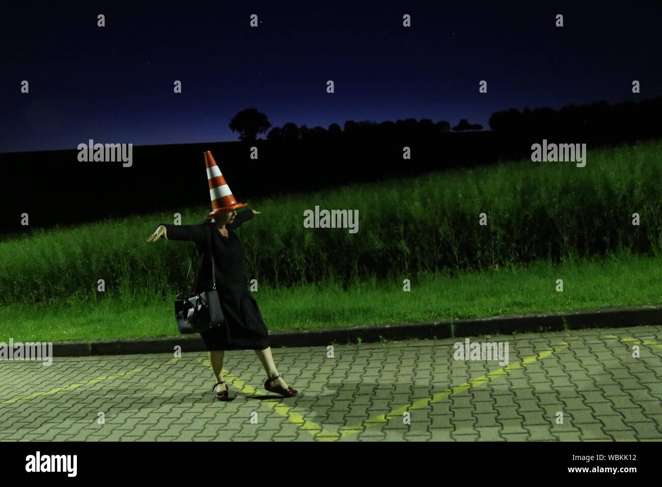 Women With Traffic Cone On Head Walking On Road Stock Photo Alamy