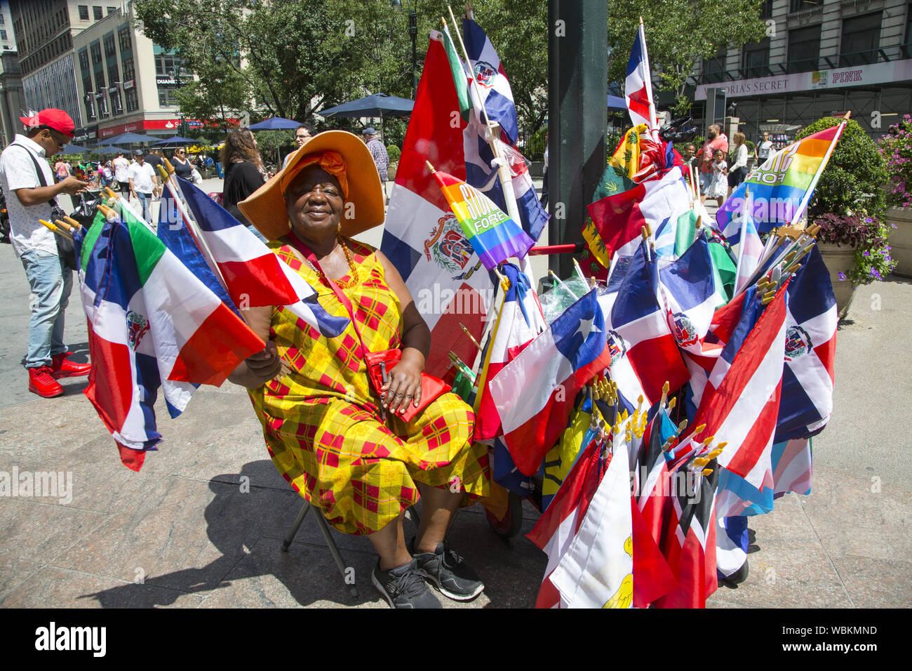 Woman sells flags at the annual Dominican Parade on 6th Avdenue in