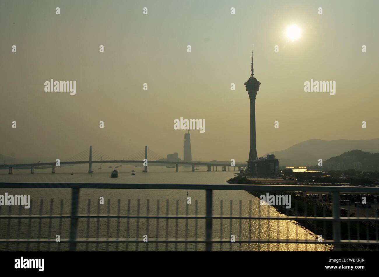 Macao Tower By River Against Sky During Sunset Stock Photo