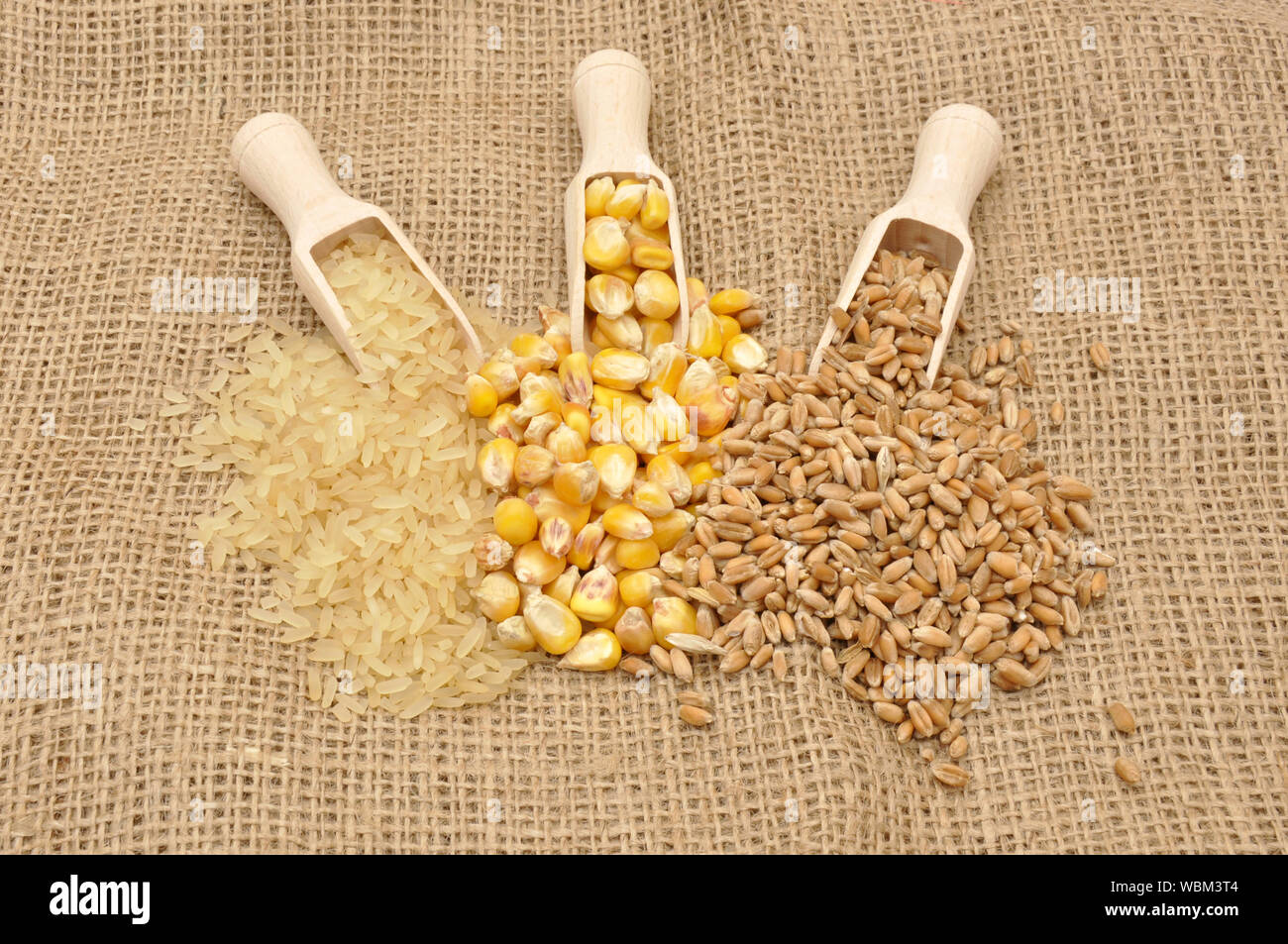 Cereals in wooden scoops on rag cloth Stock Photo - Alamy
