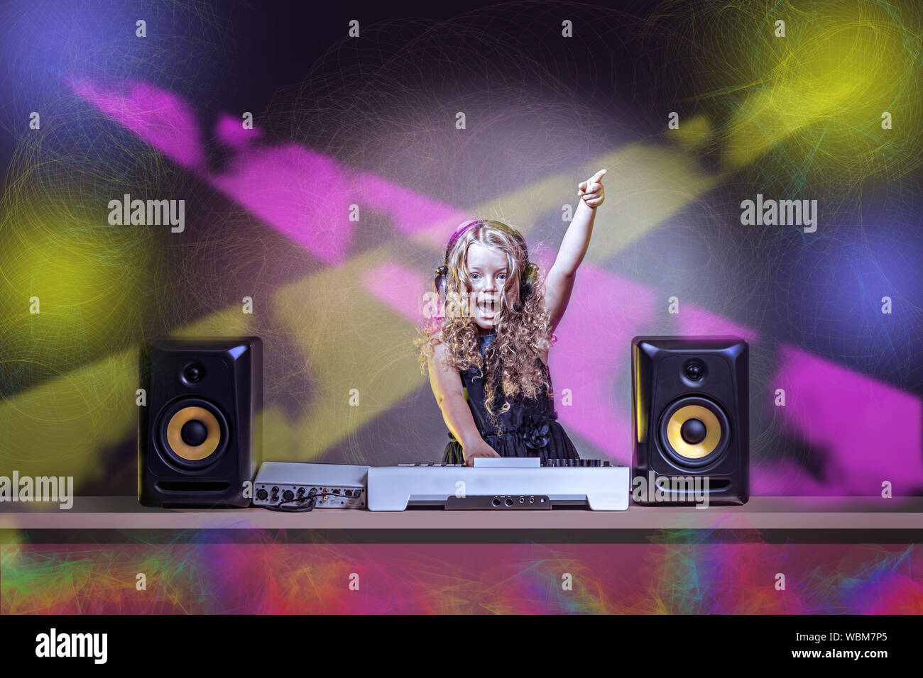 a gradeschooler girl as DJ at the kids disco Stock Photo