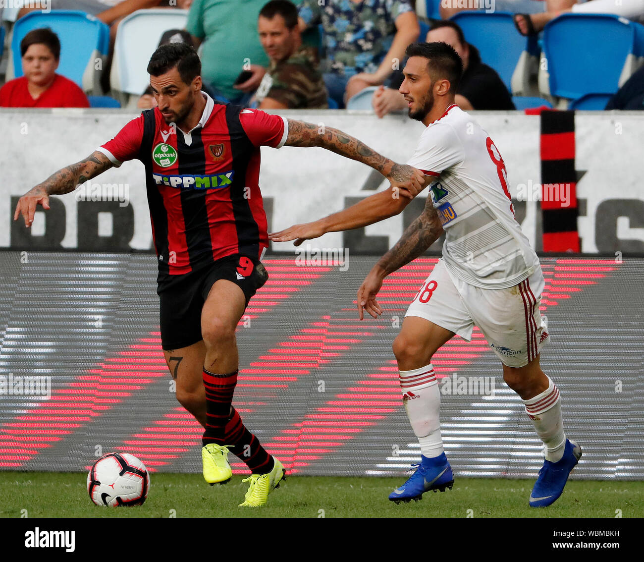 BUDAPEST, HUNGARY - AUGUST 24: (l-r) Davide Lanzafame of Budapest Honved competes for the ball with Mark Szecsi of DVSC during the Hungarian OTP Bank Liga match between Budapest Honved and DVSC at Nandor Hidegkuti Stadium on August 24, 2019 in Budapest, Hungary. Stock Photo