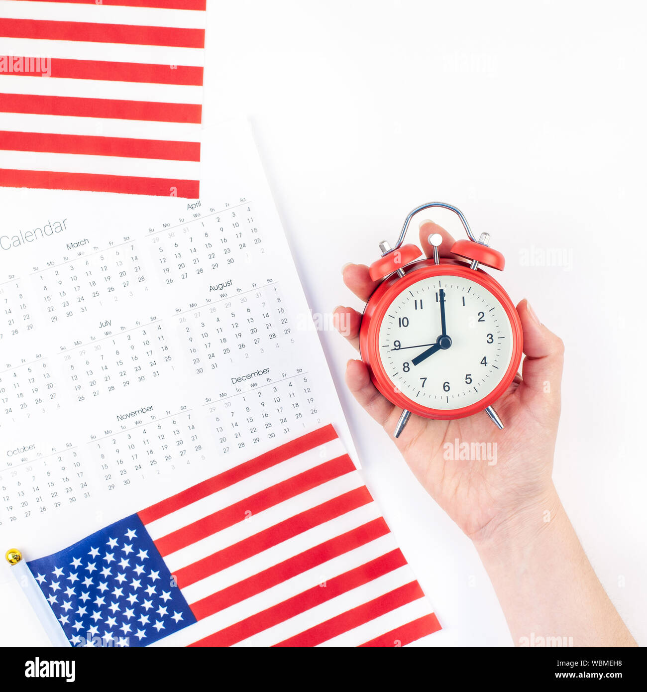 Creative top view flat lay of American flags for Elections, Memorial Day 4th of July or Labour Day with calendar copy space on white background in min Stock Photo