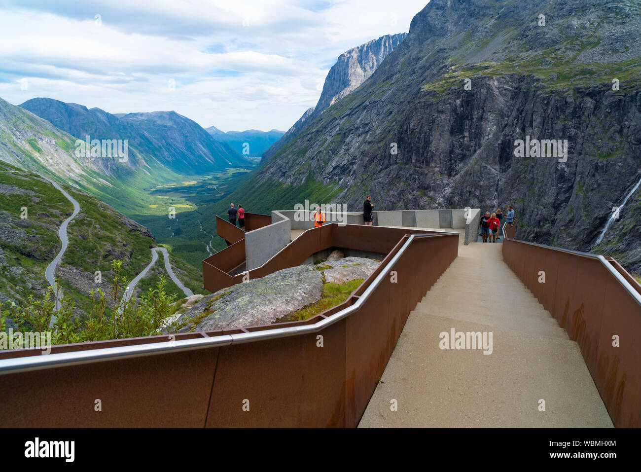 TROLLSTIGEN, NORWAY - JULY 30, 2018: Unique viewpoint platform looking out over the Trollstigen or Trolls Path, a serpentine mountain road in Rauma Mu Stock Photo