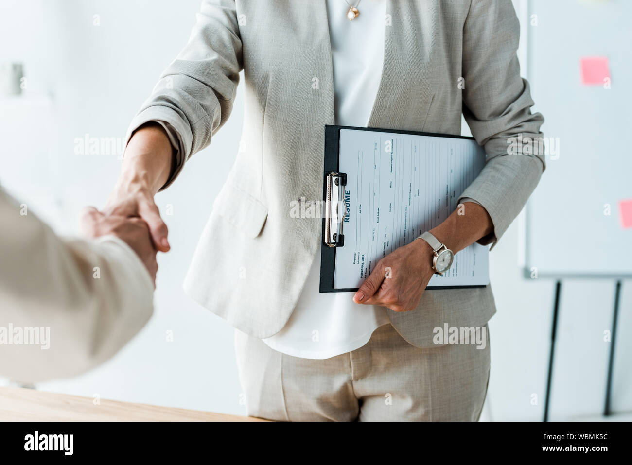 cropped view of recruiter and employee shaking hands in office Stock Photo