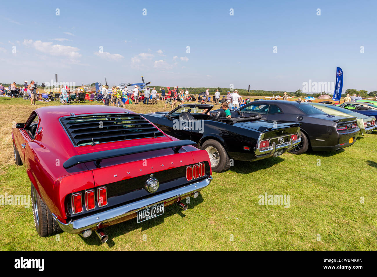 Ford Mustang car at the Children in Need Little Gransden Air and Car Show, with P-51 Mustang plane and people Stock Photo