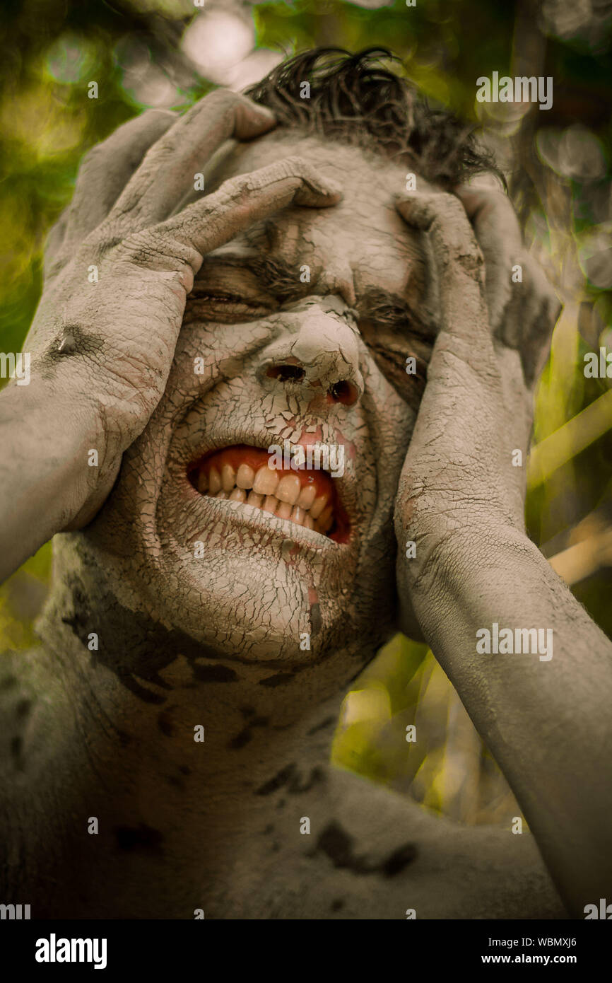 Face of man with mud suffering Stock Photo